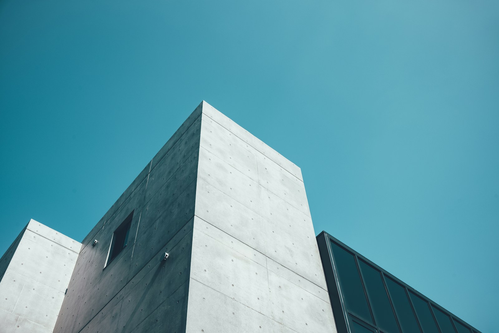 Sunlit concrete architecture against an open blue sky